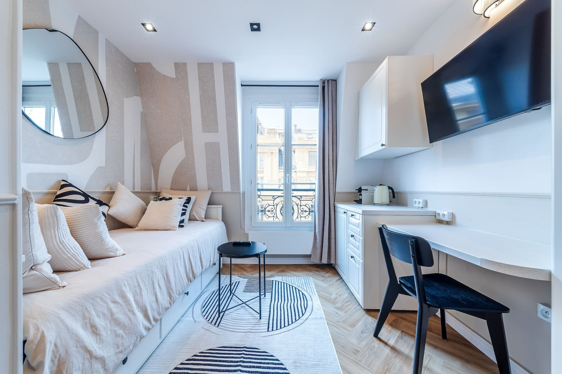 Studio living space with kitchenette and desk