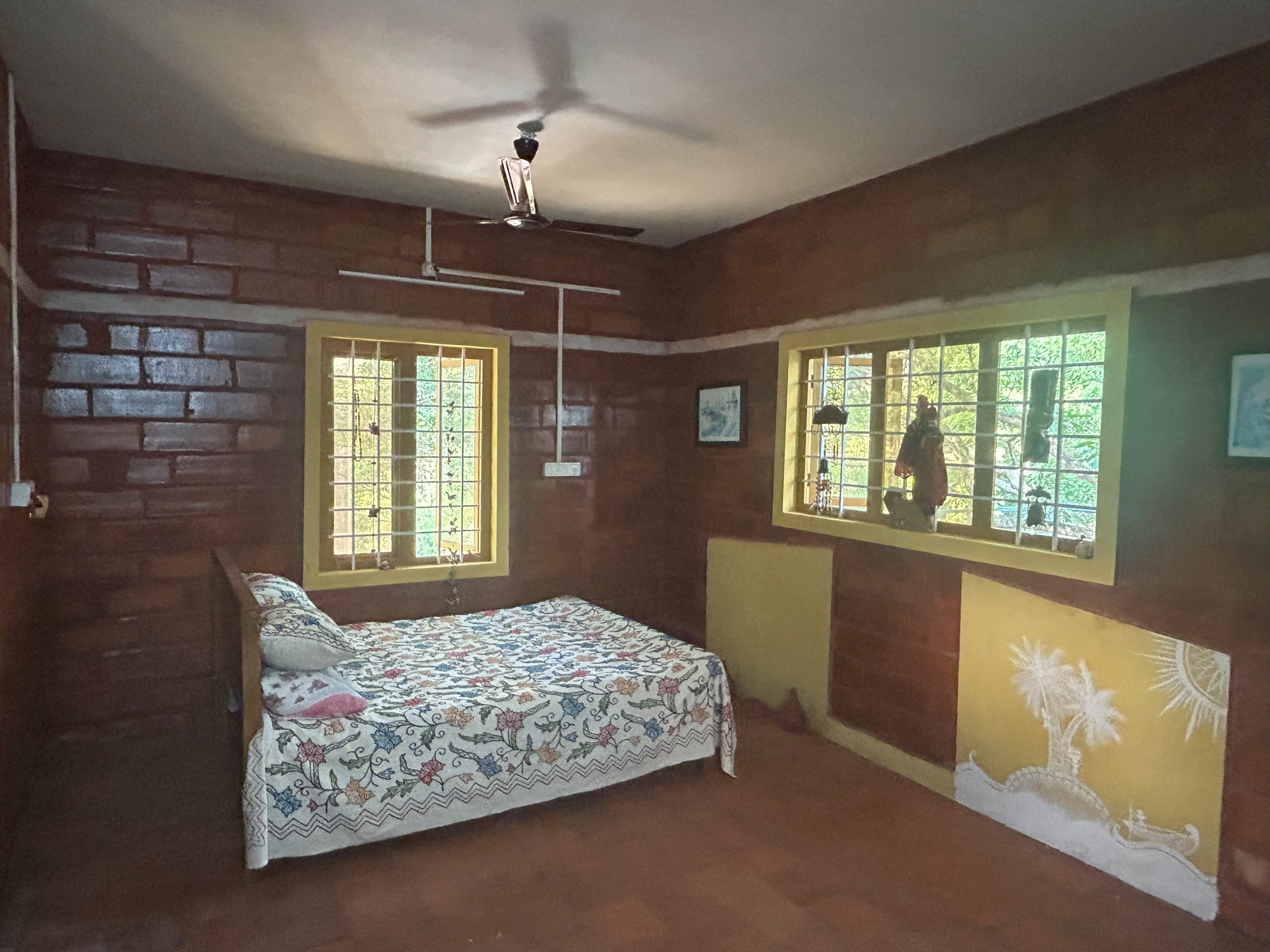 Bedroom with floral bedspread, wall art