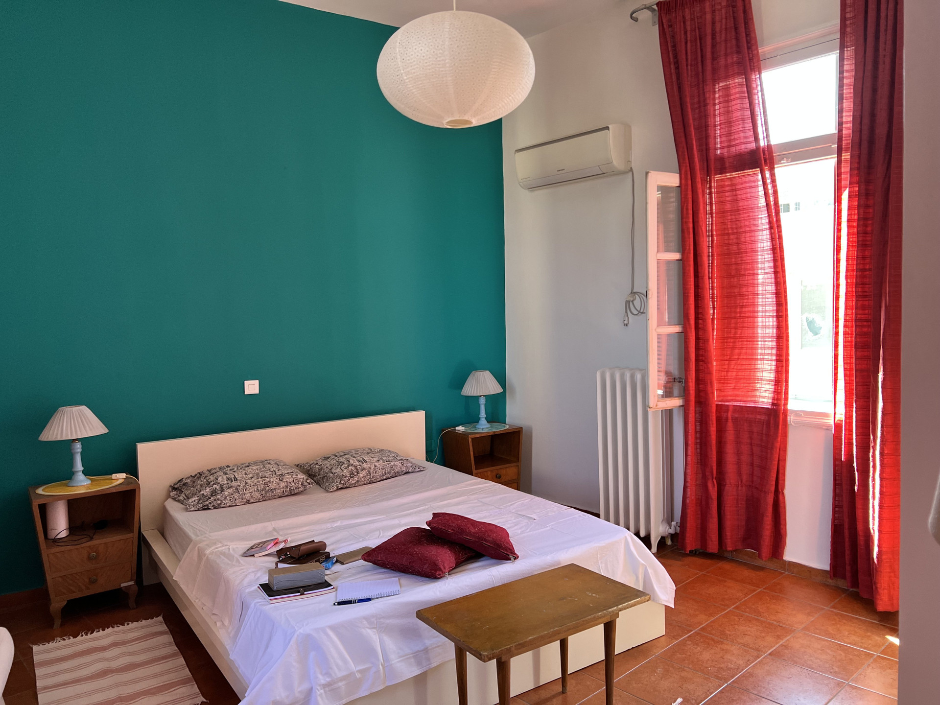 Bedroom bright with red curtains
