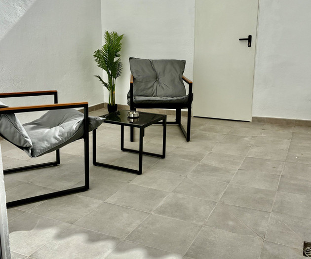 Private tiled patio with seating