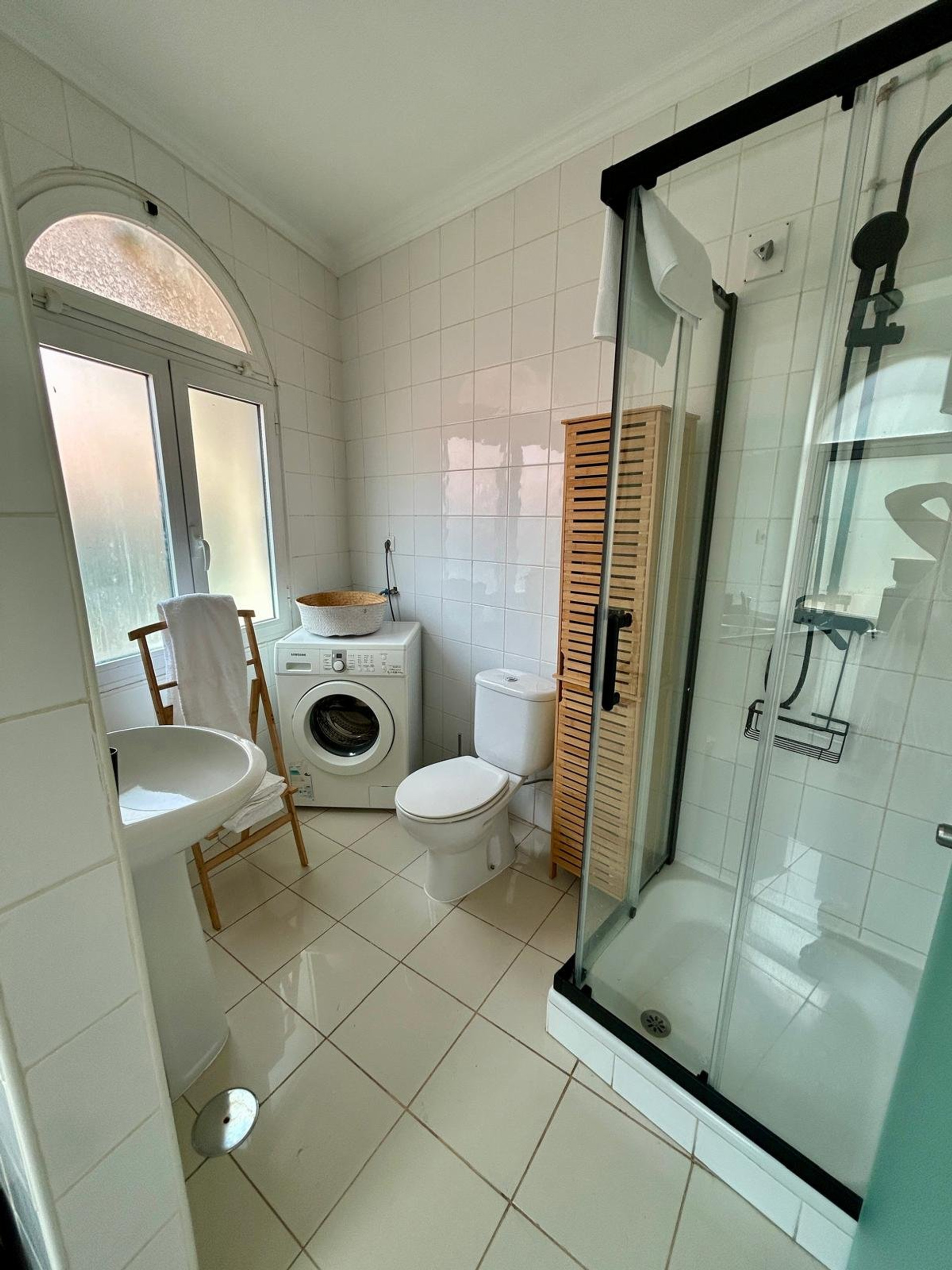 Bathroom with shower and washing machine