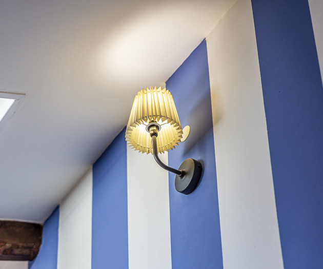Wall lamp on striped wall