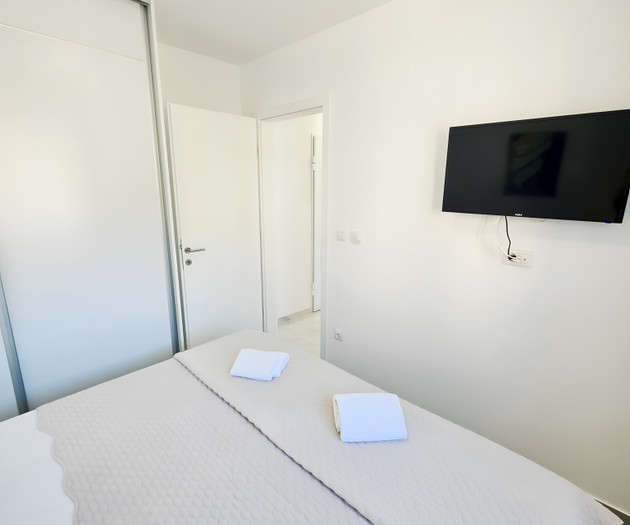 Bedroom with wall-mounted TV