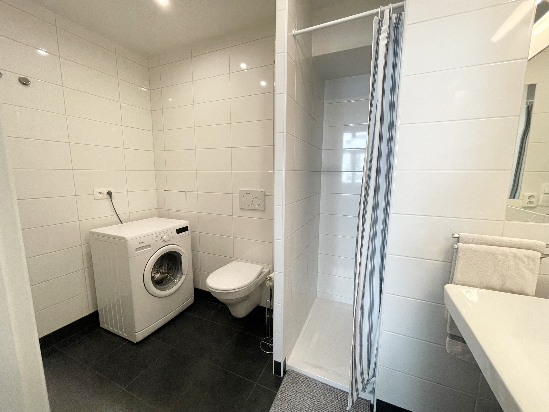 Bathroom with shower and washing machine