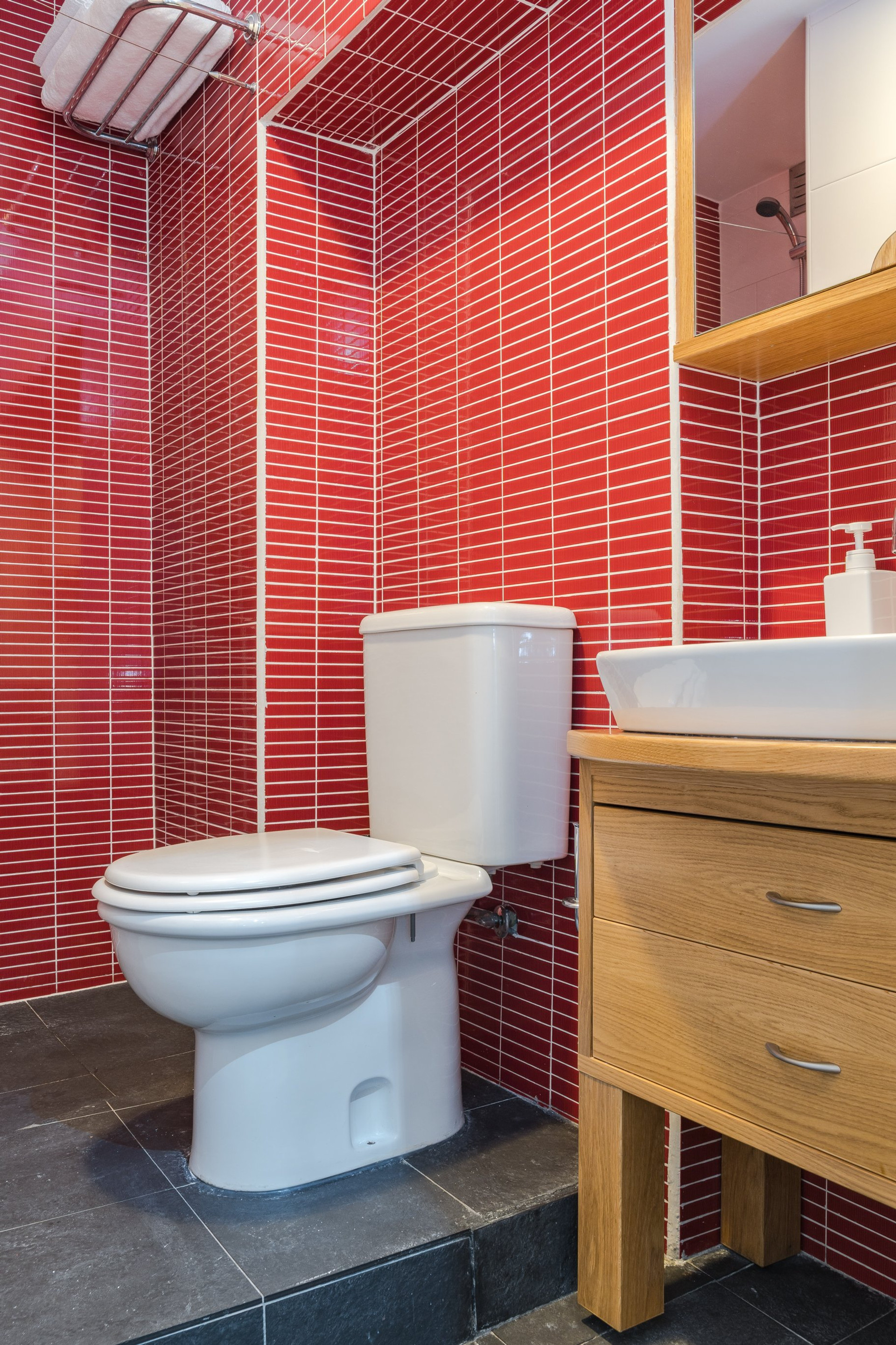 Bathroom with red tile and toilet