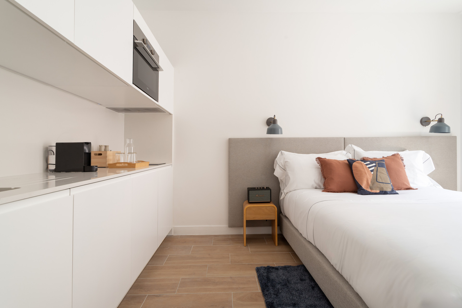Kitchen counter beside cozy bed