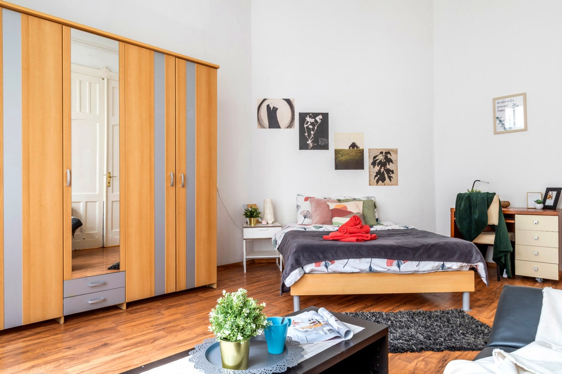 Bright bedroom with large windows and workspace