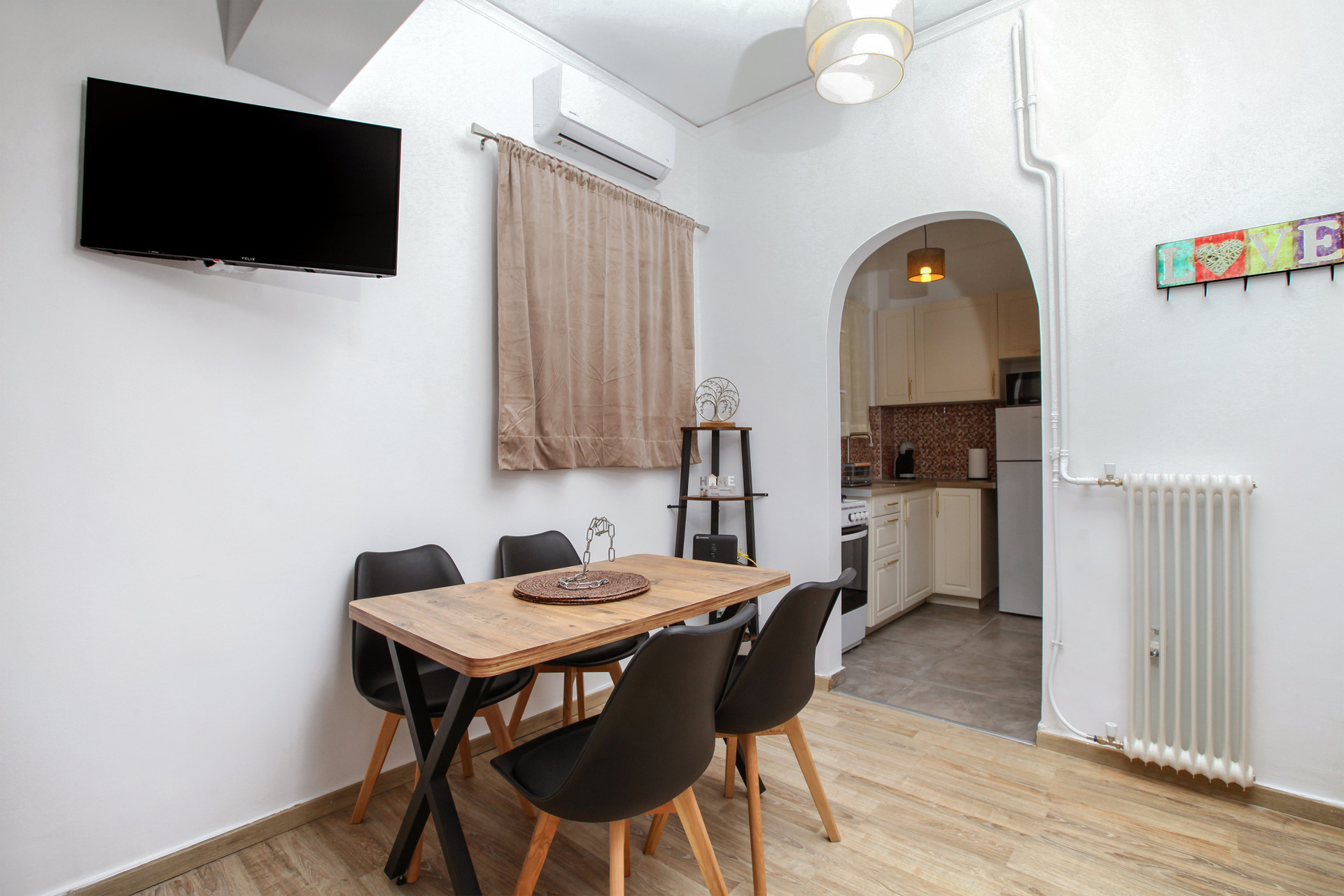 Dining area with arched kitchen entrance