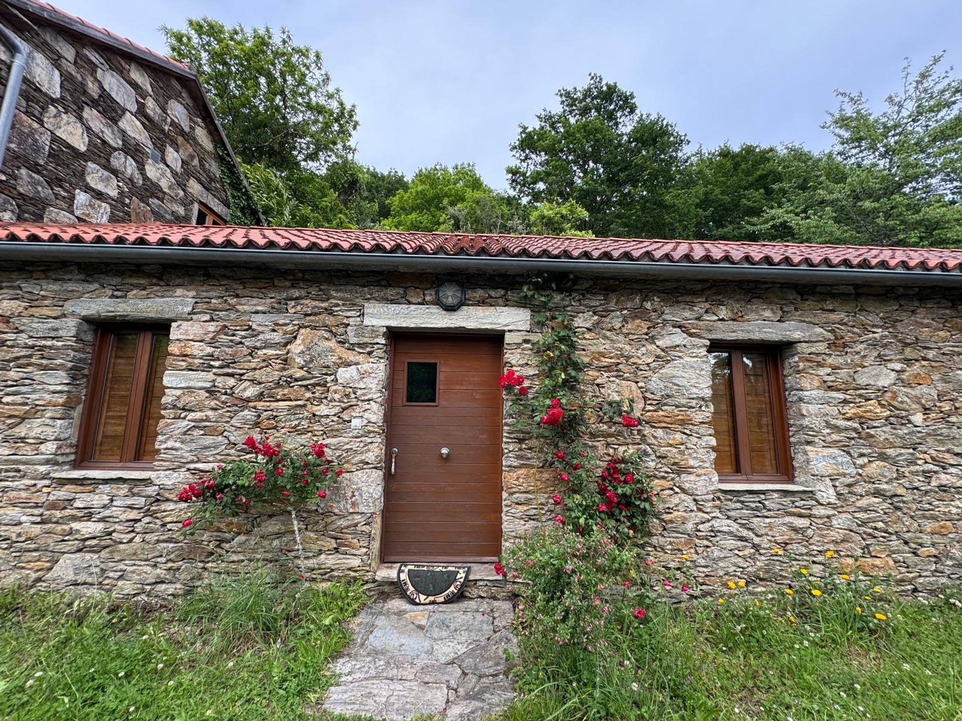 Stone cottage exterior with roses