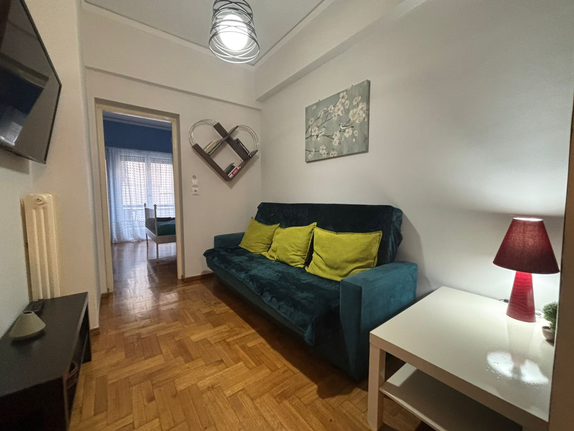 Living room with teal sofa