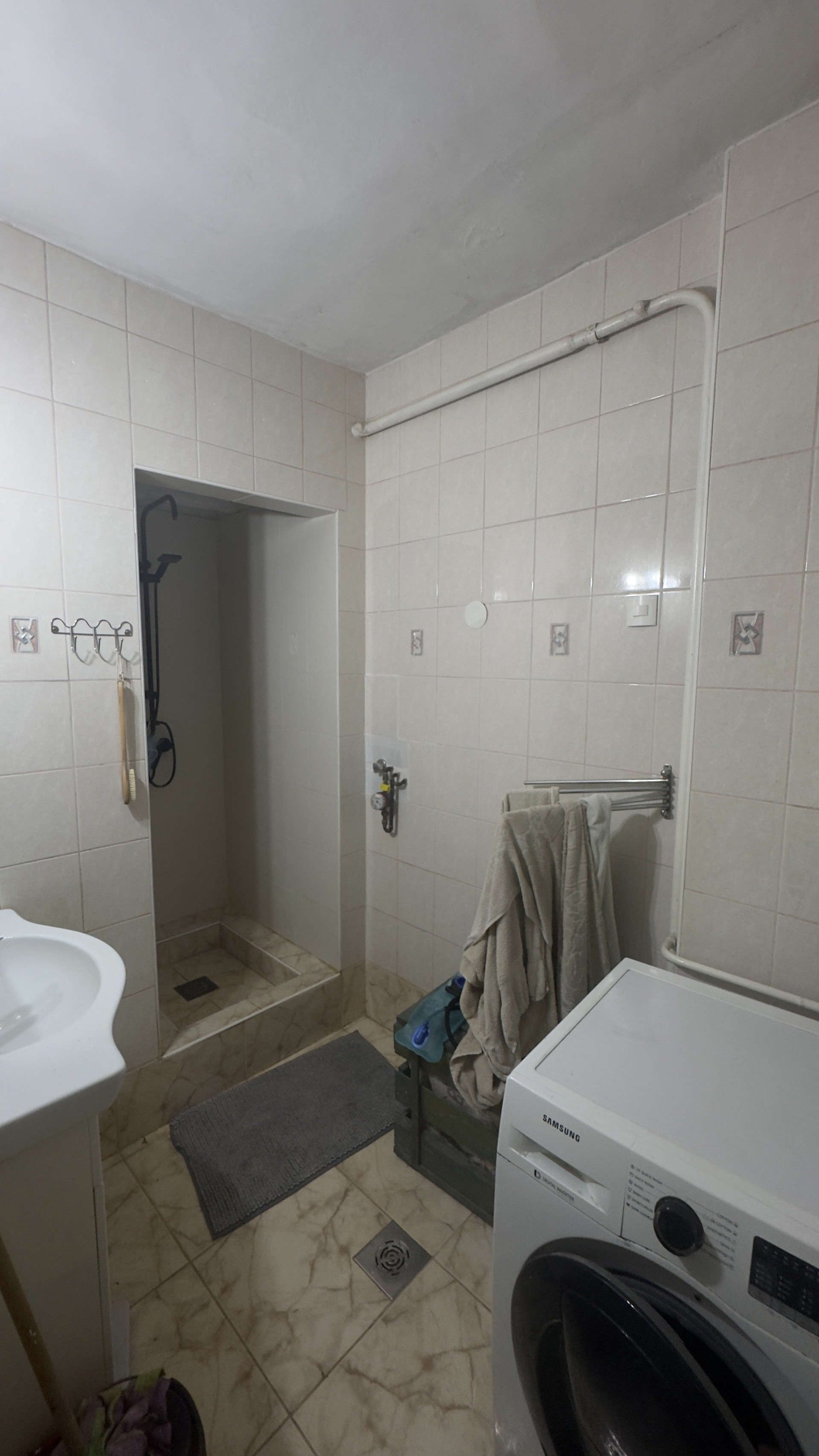 Bathroom with shower and washer