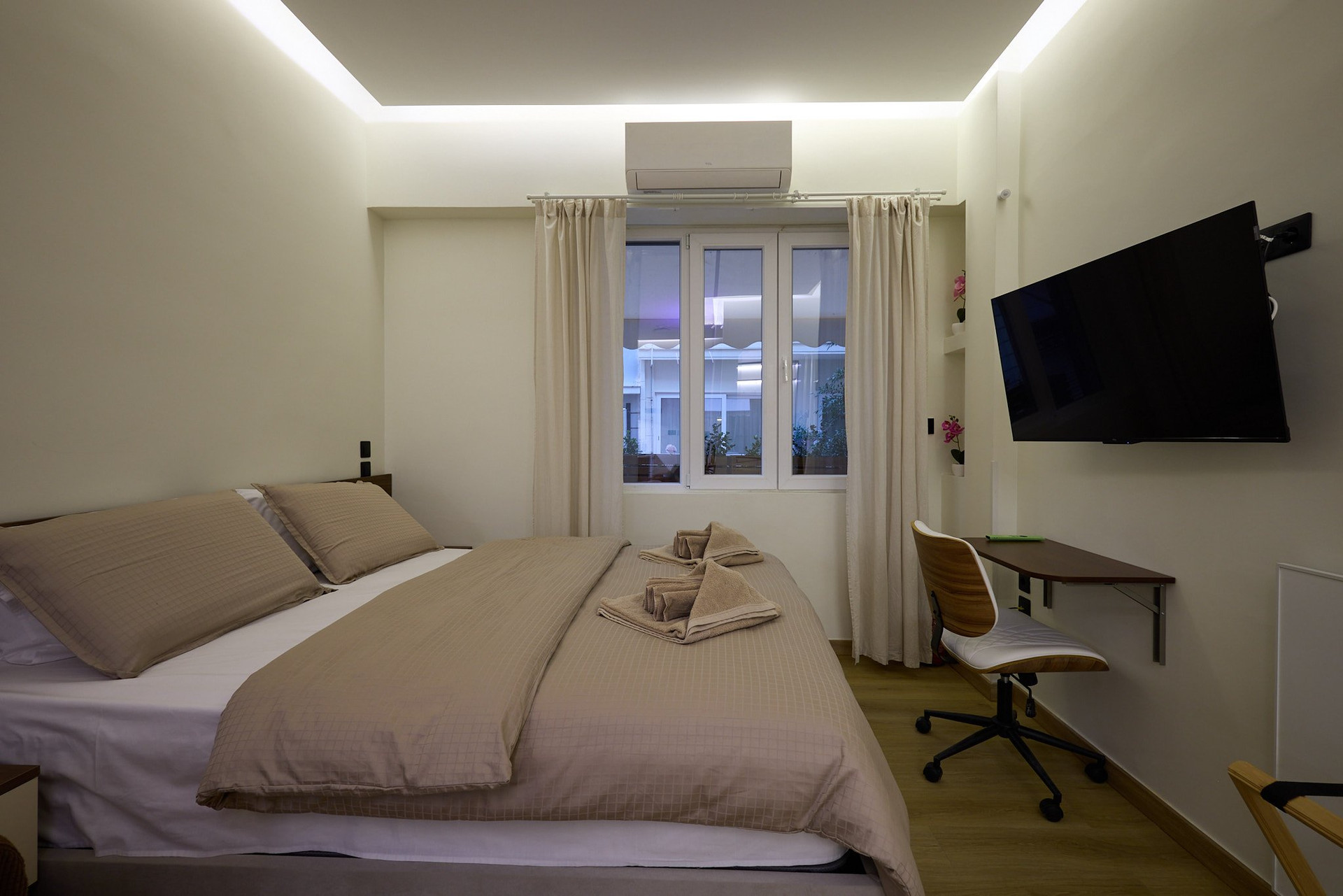 Bright bedroom with TV and desk