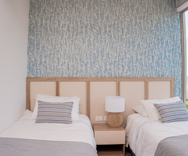 Twin beds with blue accent wall