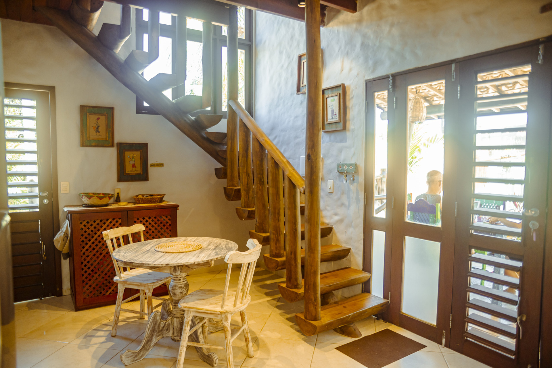 Dining nook beside wooden staircase