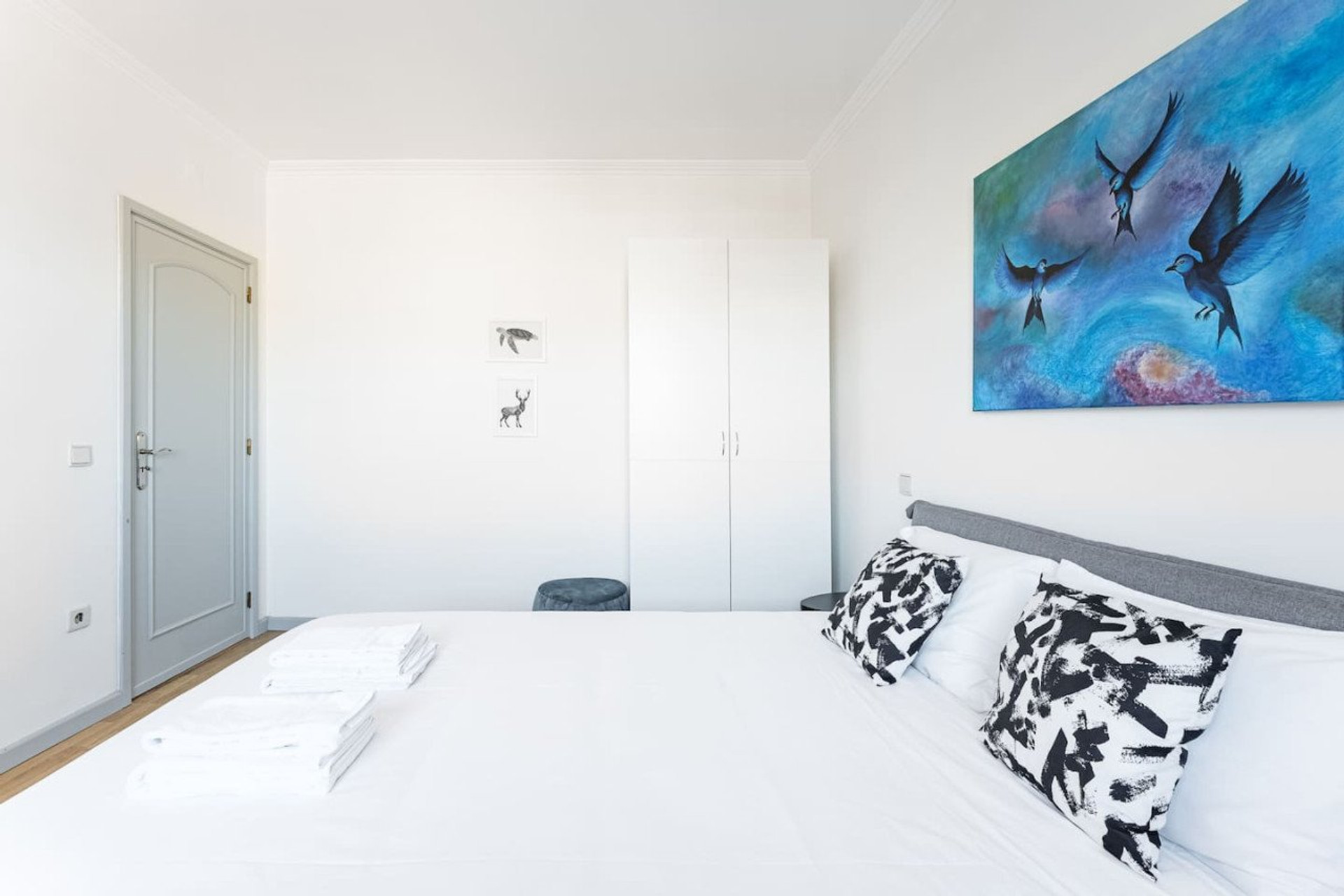 Bedroom with blue bird artwork
