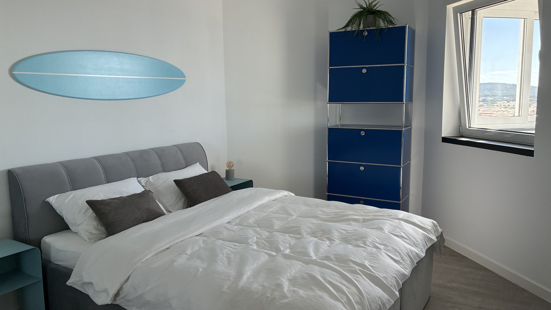 Bedroom with surfboard decor and window