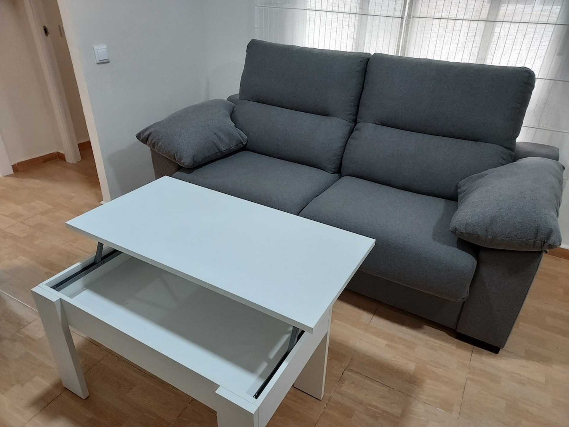 Coffee table in elevated position that allows for lunch and dinner.