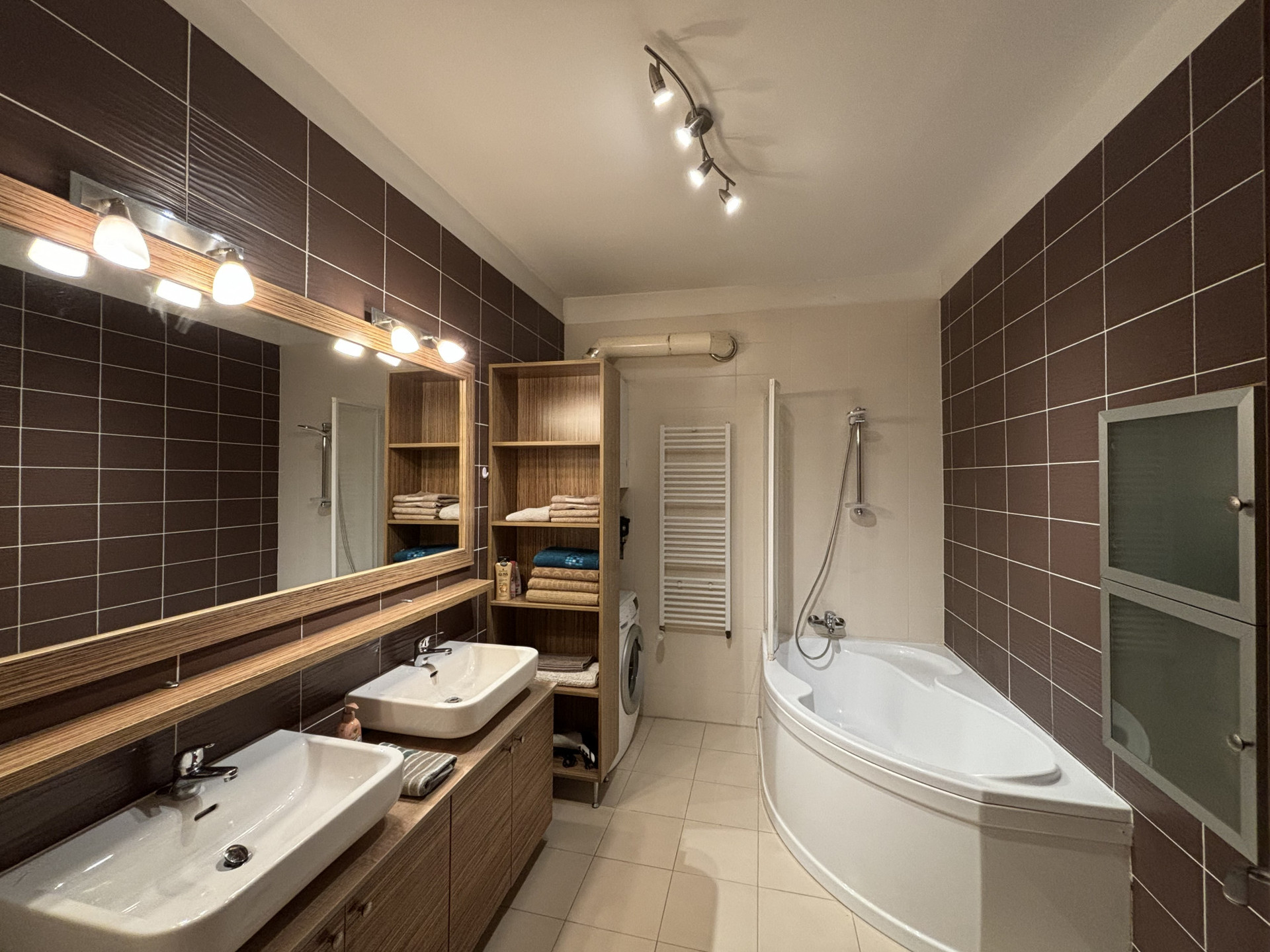 Bathroom with double vanity, tub with shower, washing machine and plenty of storage. Towels and hairdryer available.