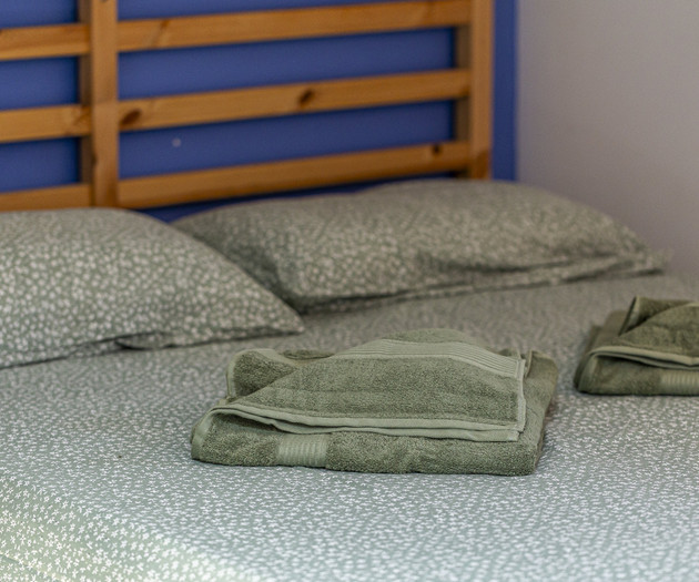 Bed with towels and headboard