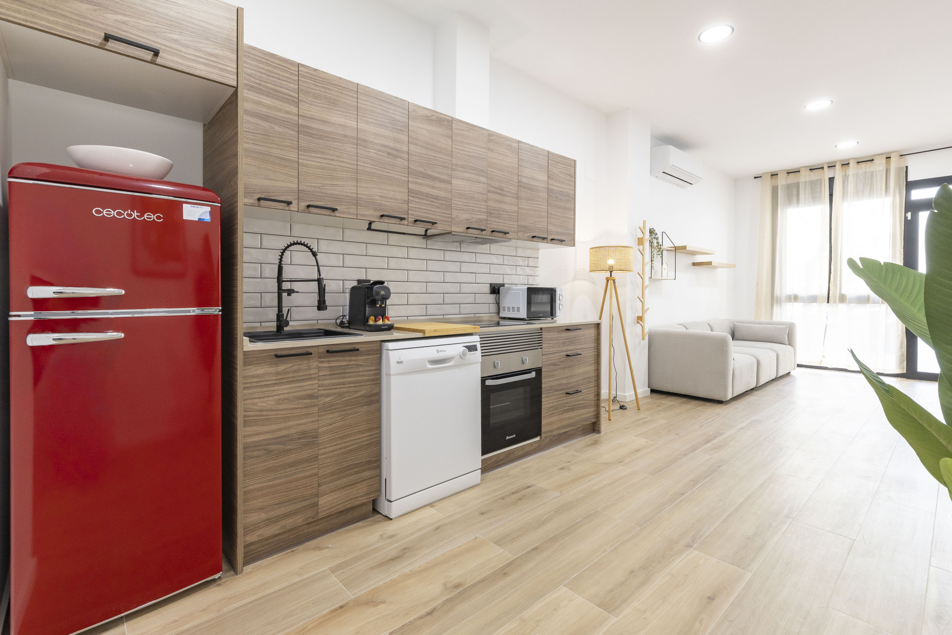Kitchen with red fridge and sofa