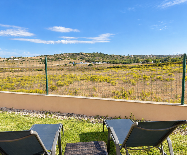 Sun loungers facing countryside view