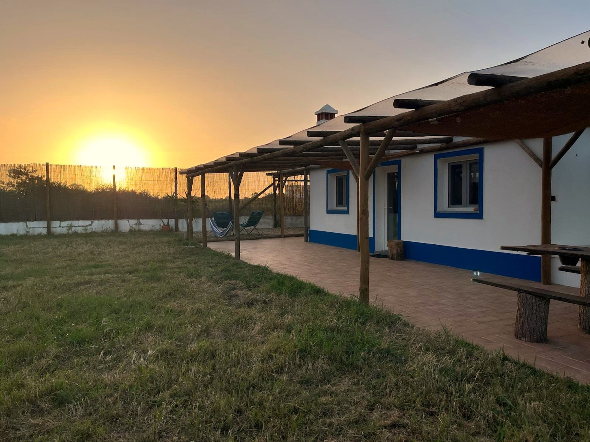 House exterior at sunset with pergola