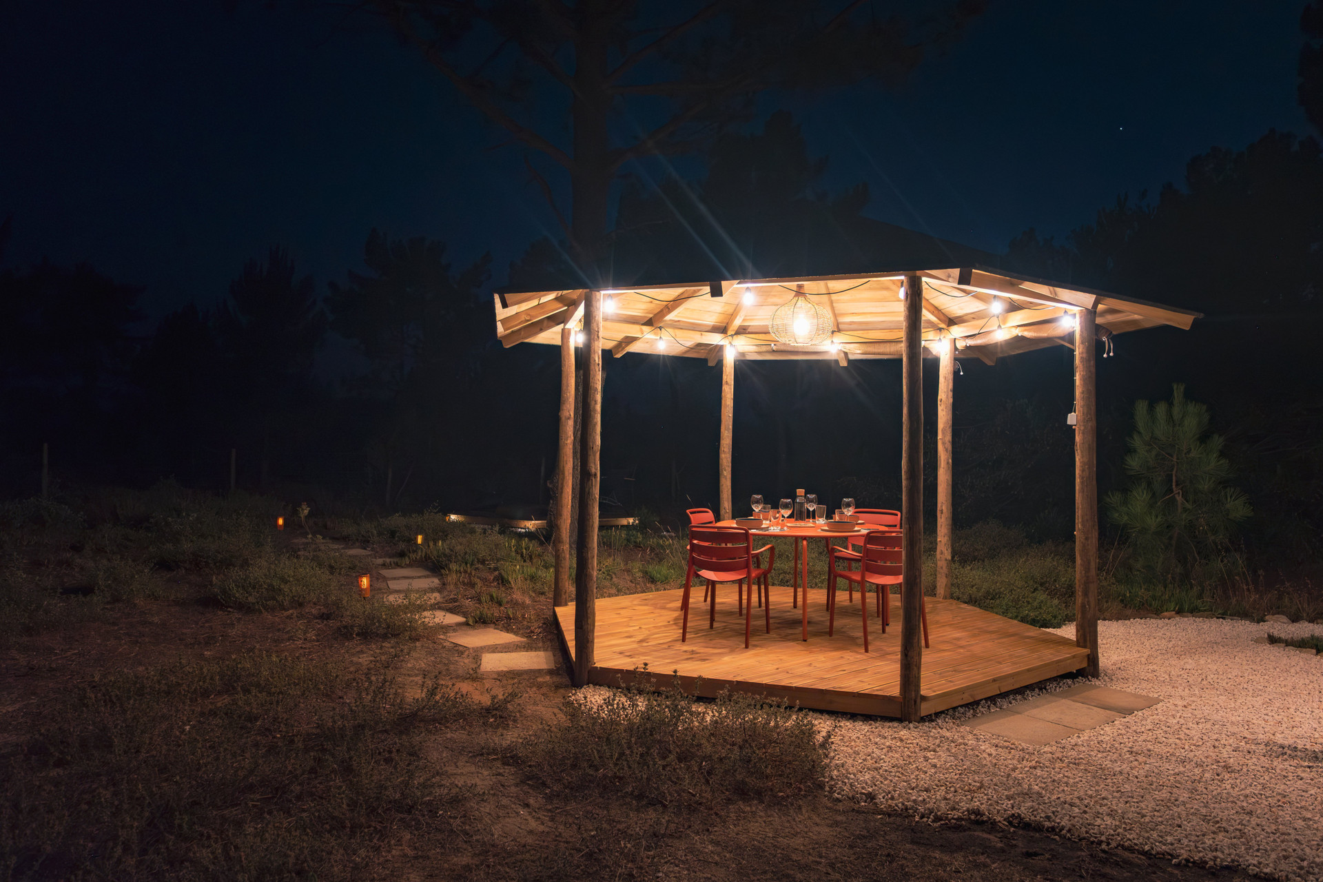Lit gazebo dining area at night