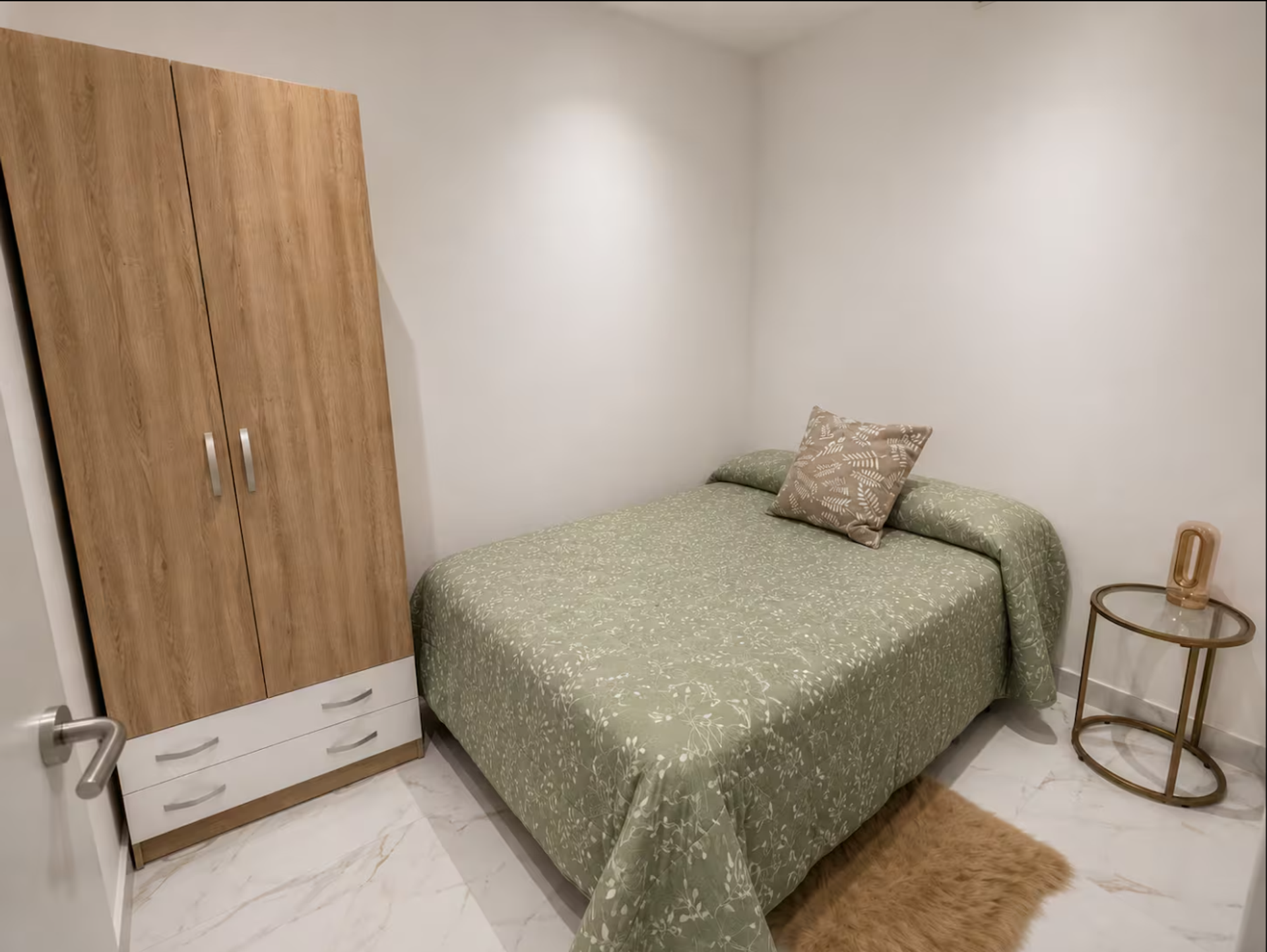 Bedroom with wardrobe and green bedspread