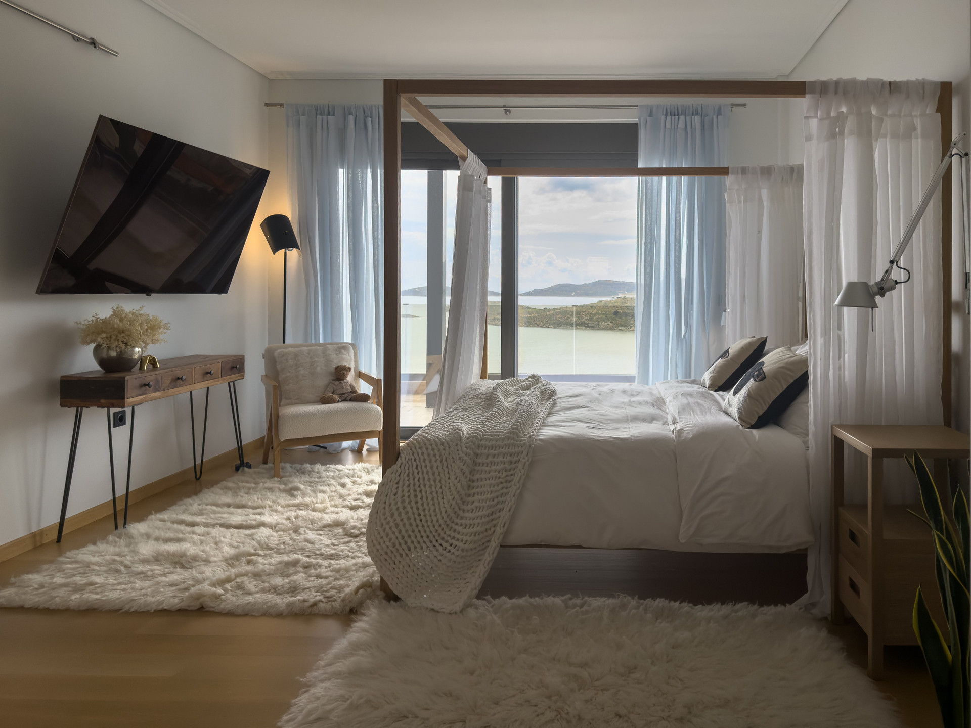 Bright bedroom four-poster sea view