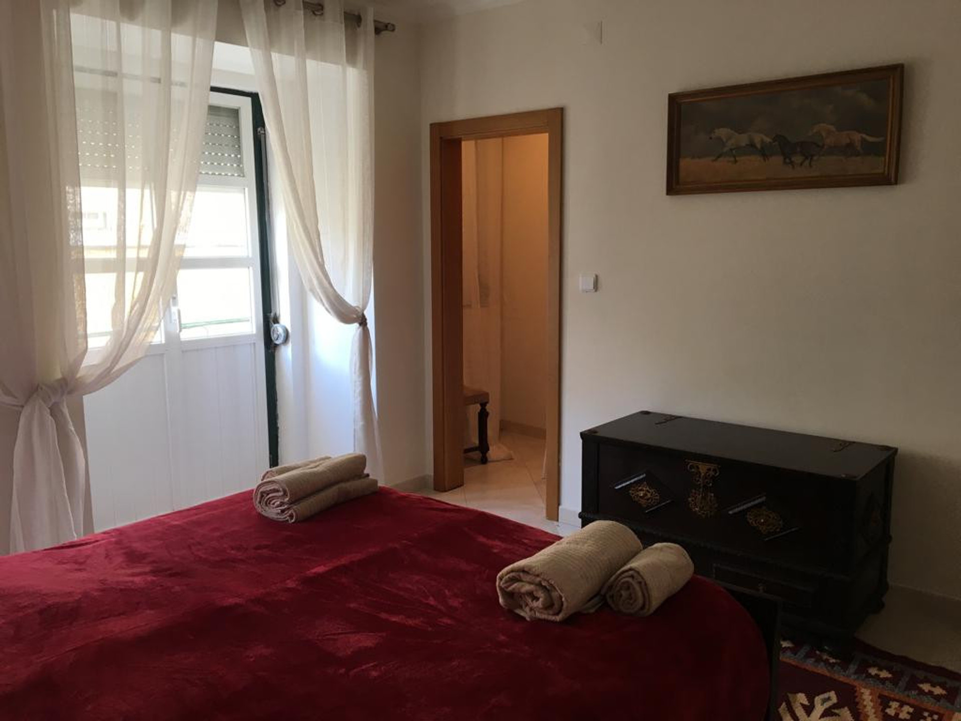 The main double bedroom with a balcony and storage closet