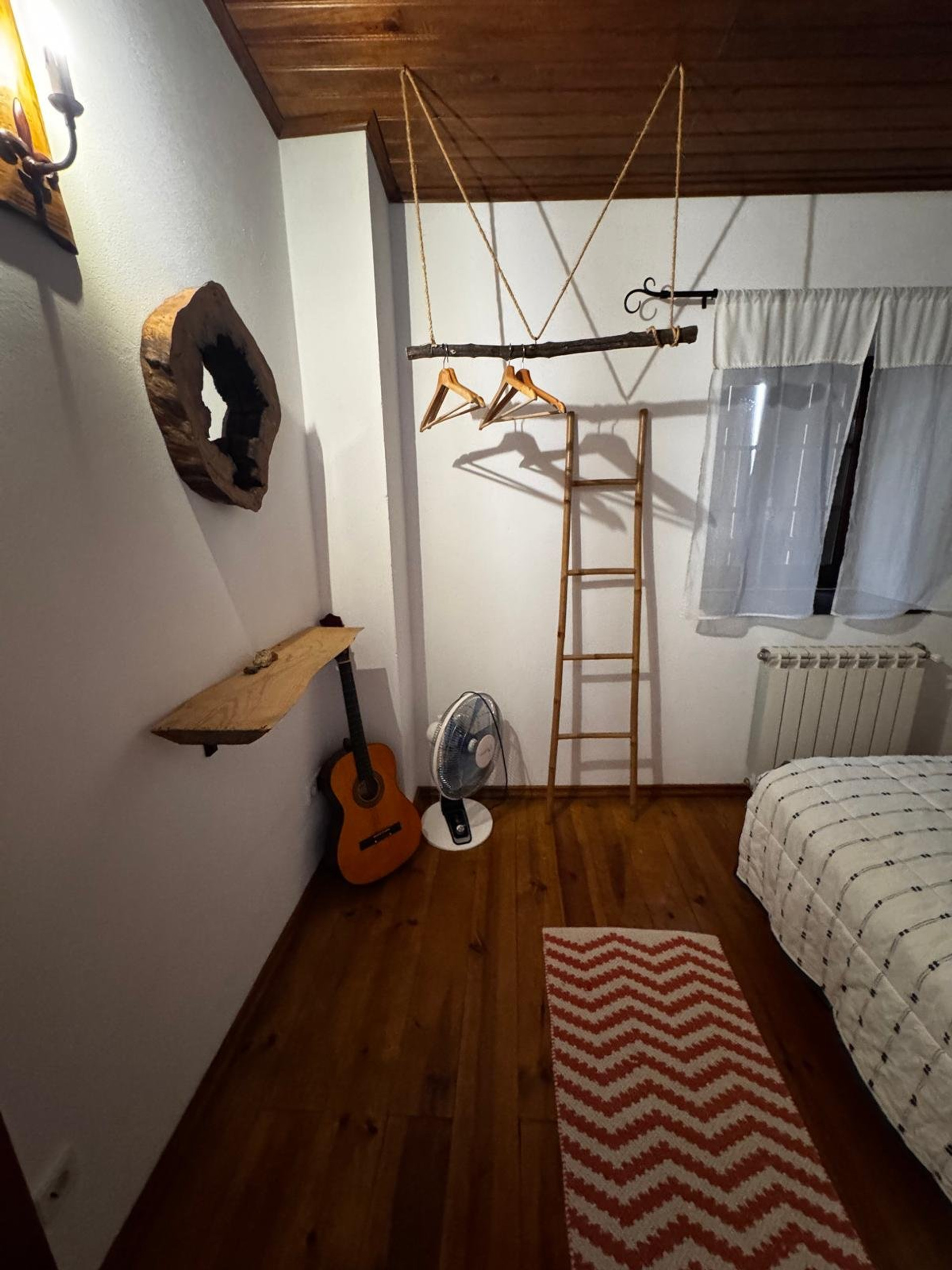 Bedroom corner with guitar ladder hanger