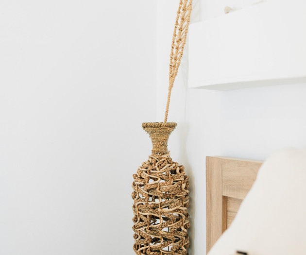 Woven vase by nightstand