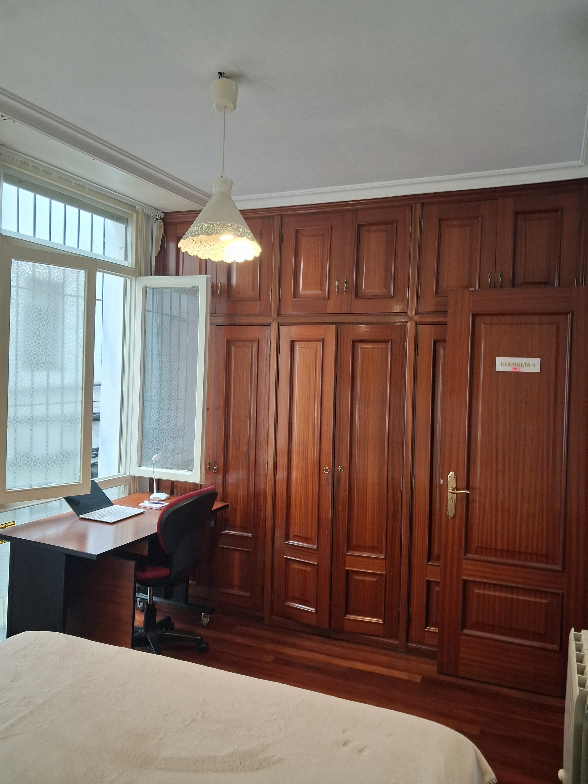 Desk and wardrobes with window