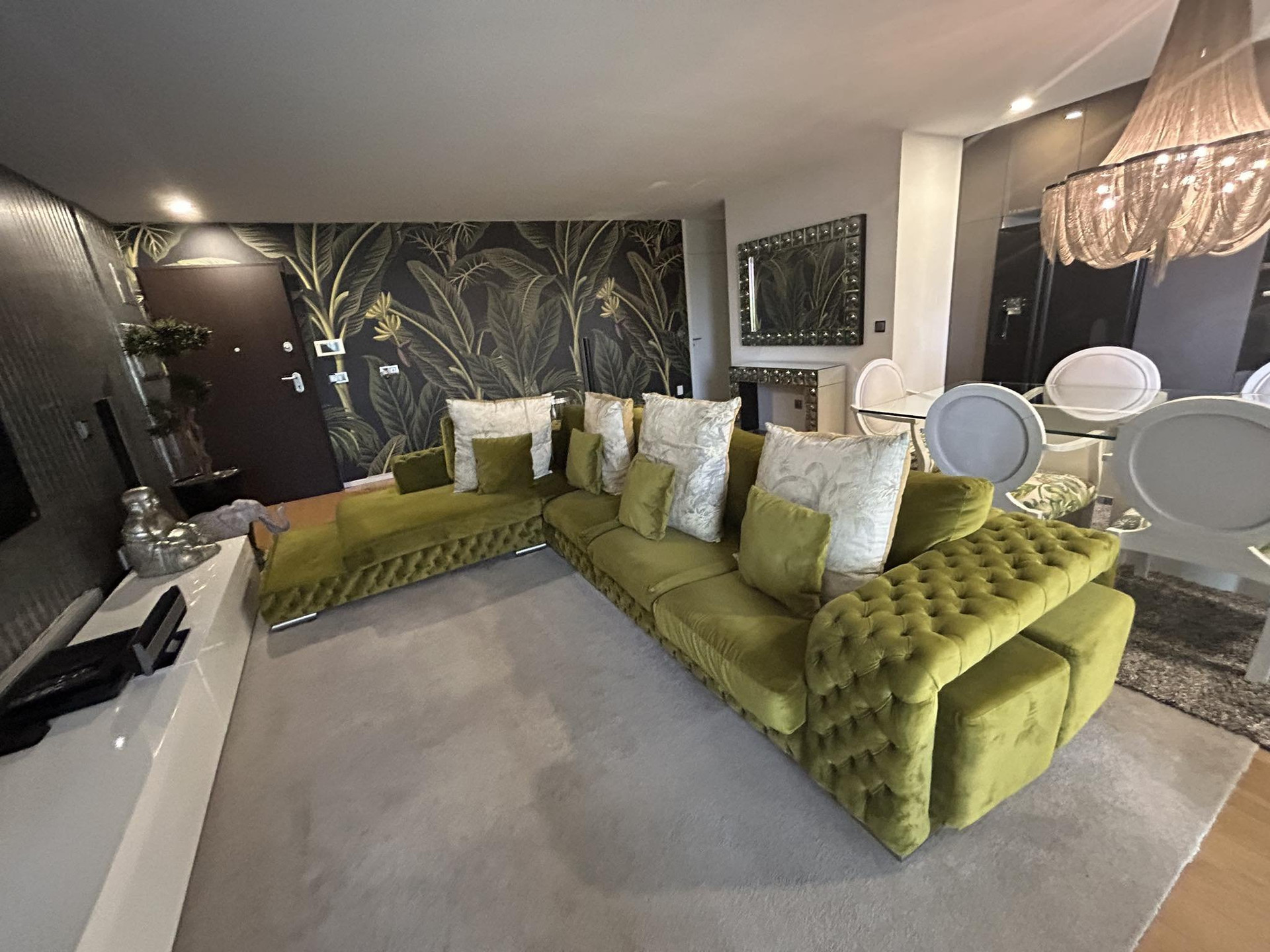 Living room with green velvet sofa