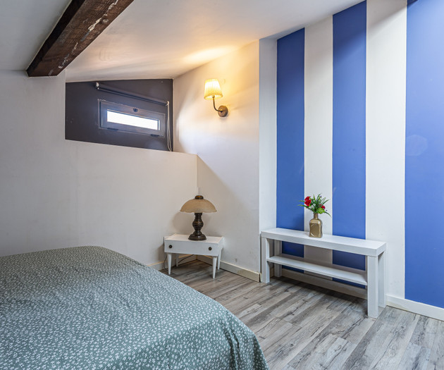 Loft bedroom with striped wall