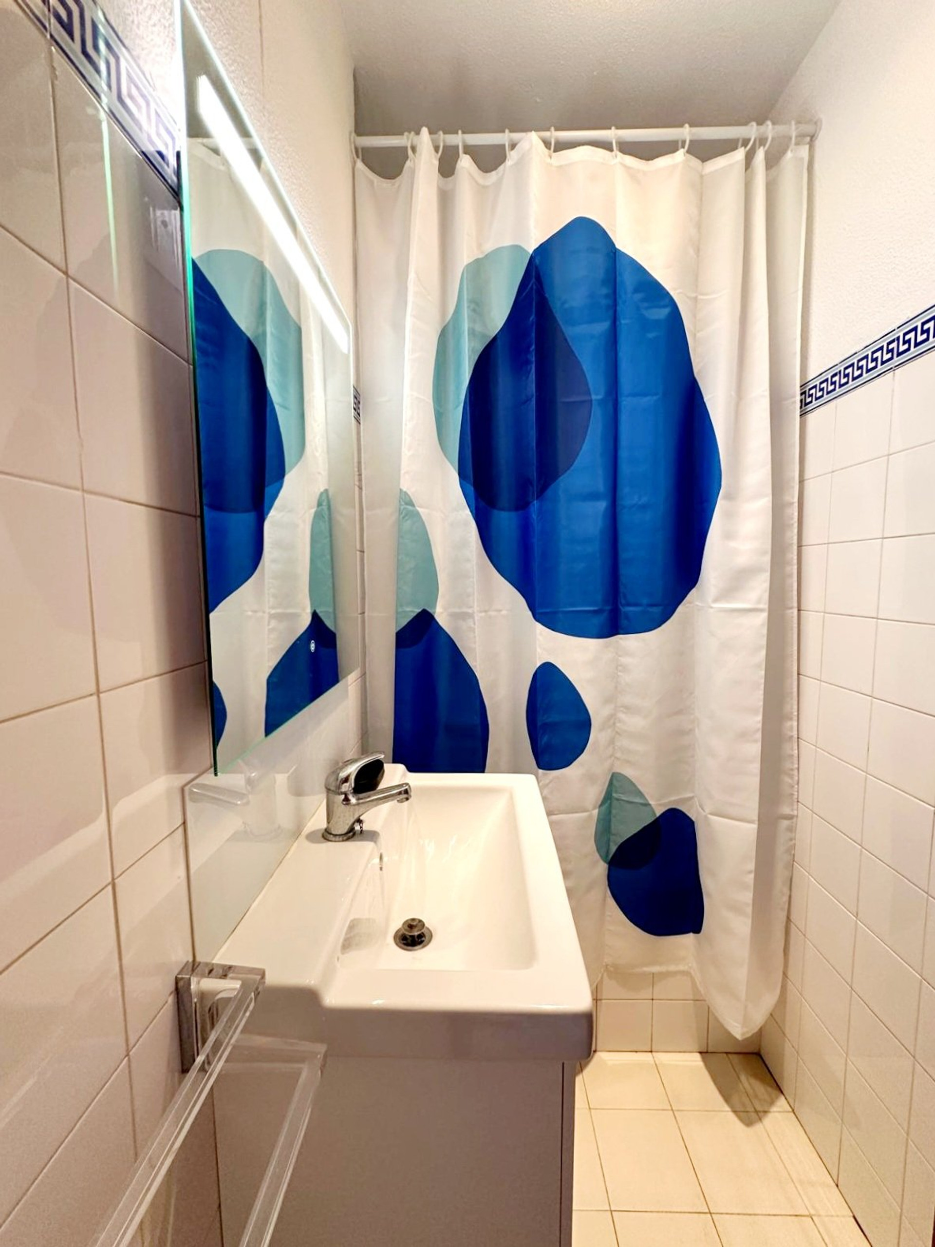 Bathroom with colorful shower curtain