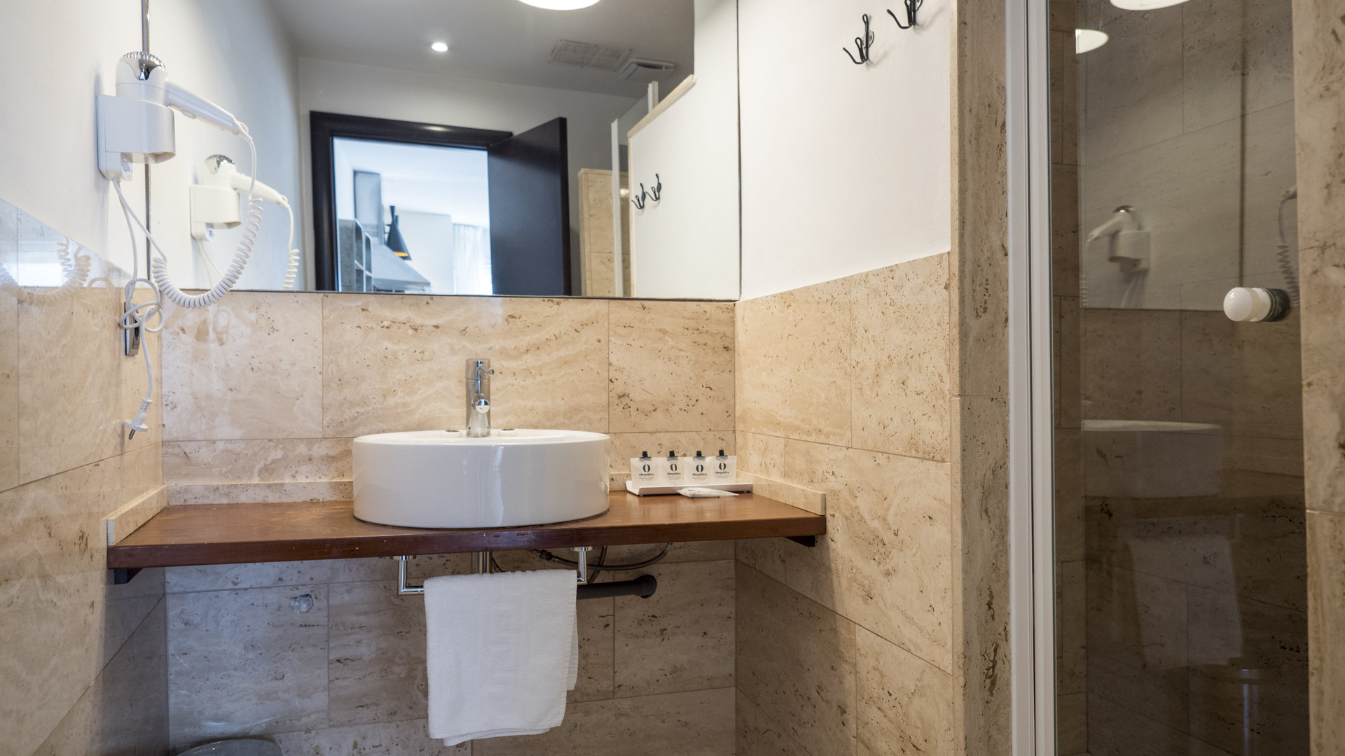 Marble bathroom with vessel sink shower