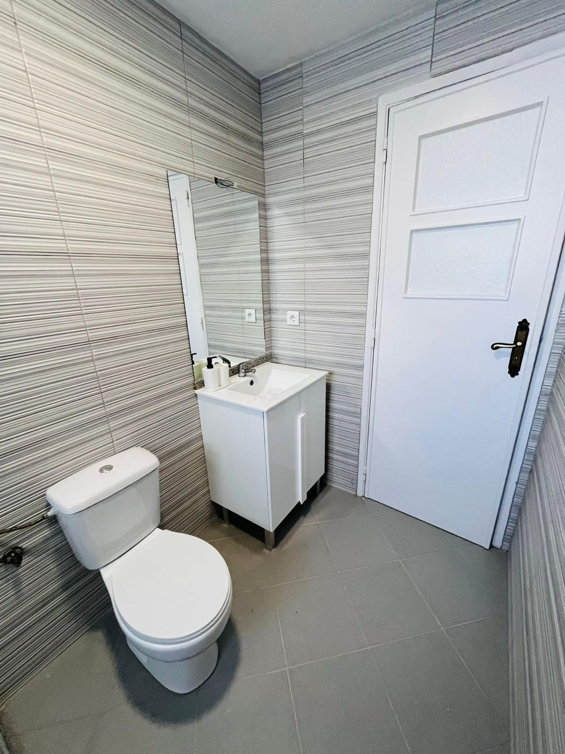 Compact bathroom with vanity mirror
