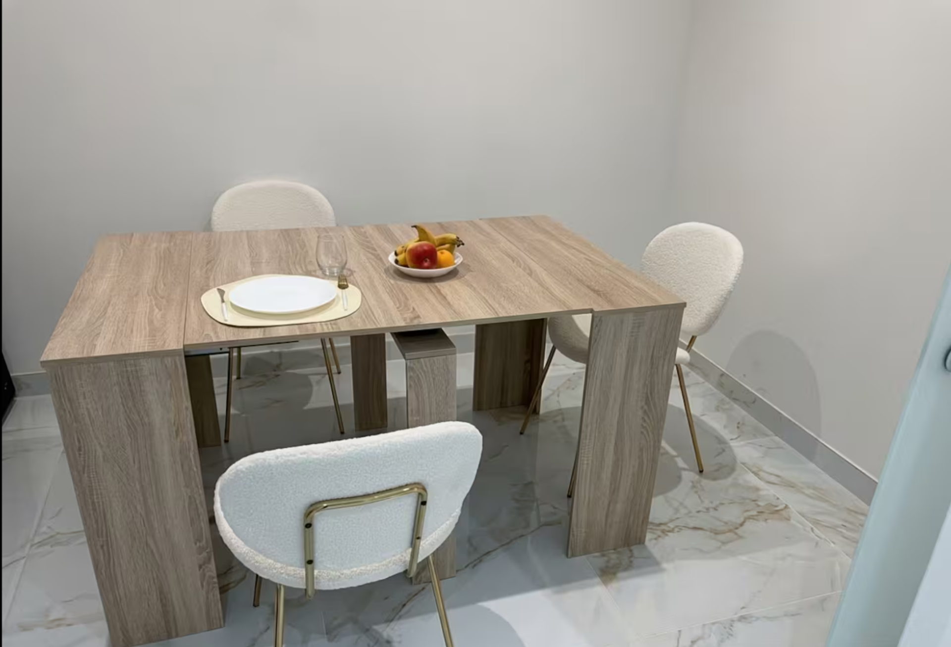 Wooden dining table with white chairs