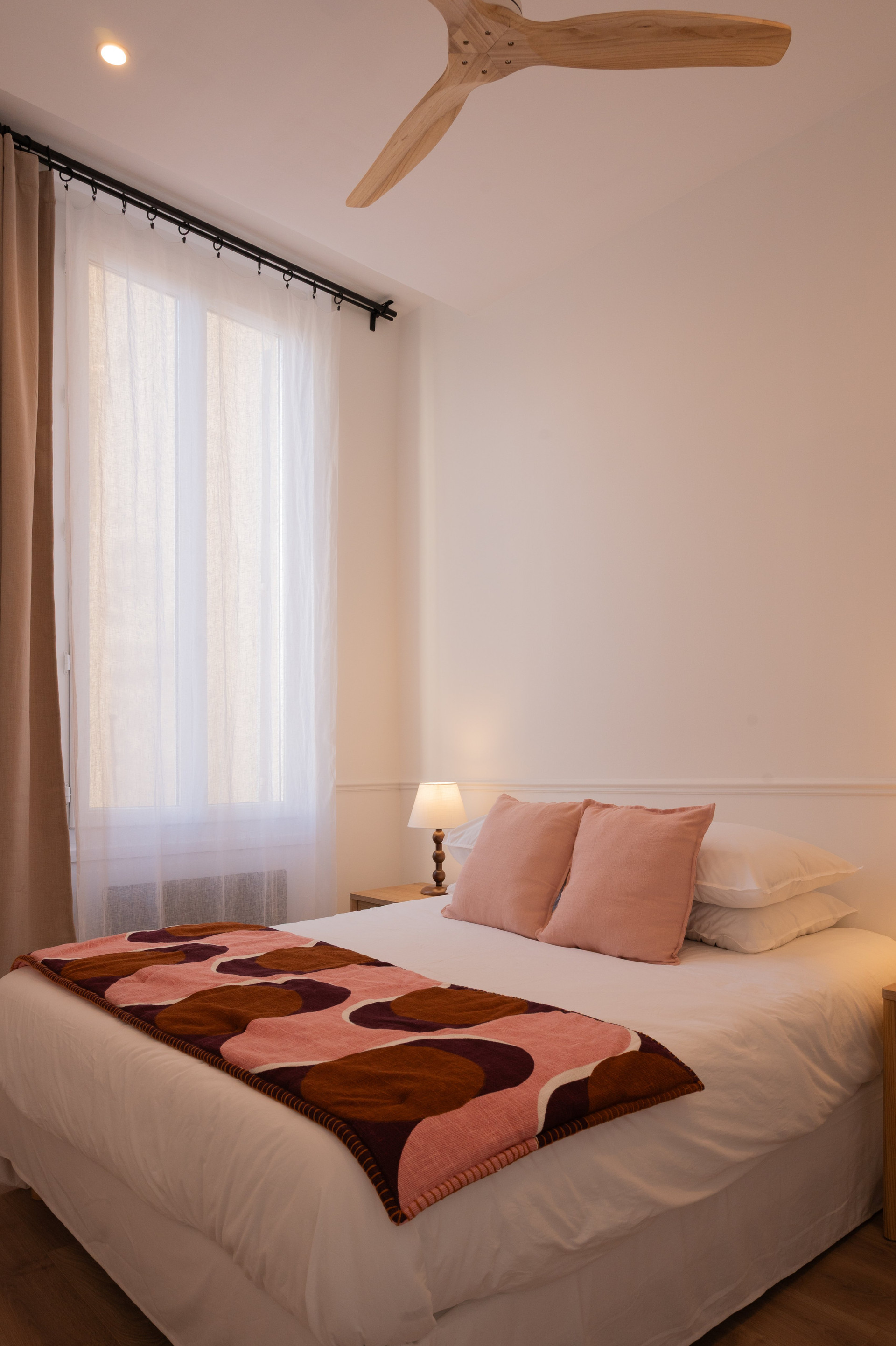 Bedroom with pink accent pillows