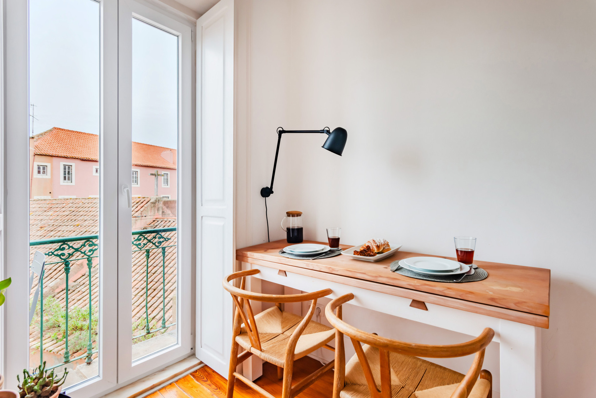 Living Room with a comfortable sofa, TV, Air Conditioning, Dining table for 2 and access to the balcony.