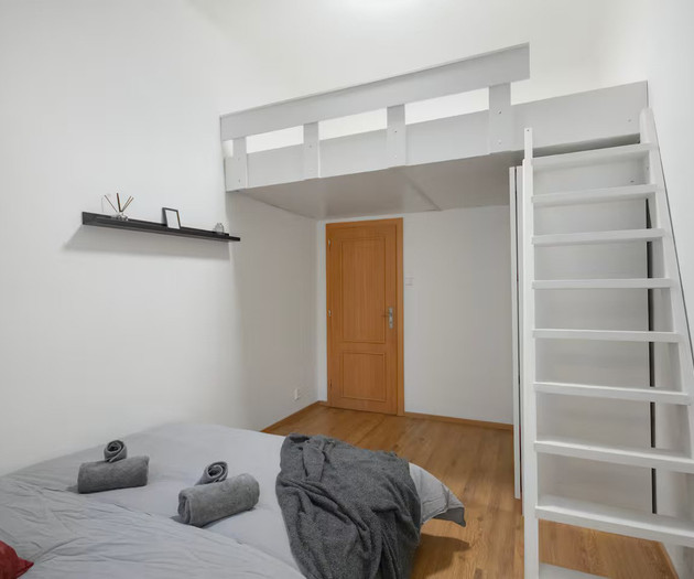 Bedroom with white loft and ladder