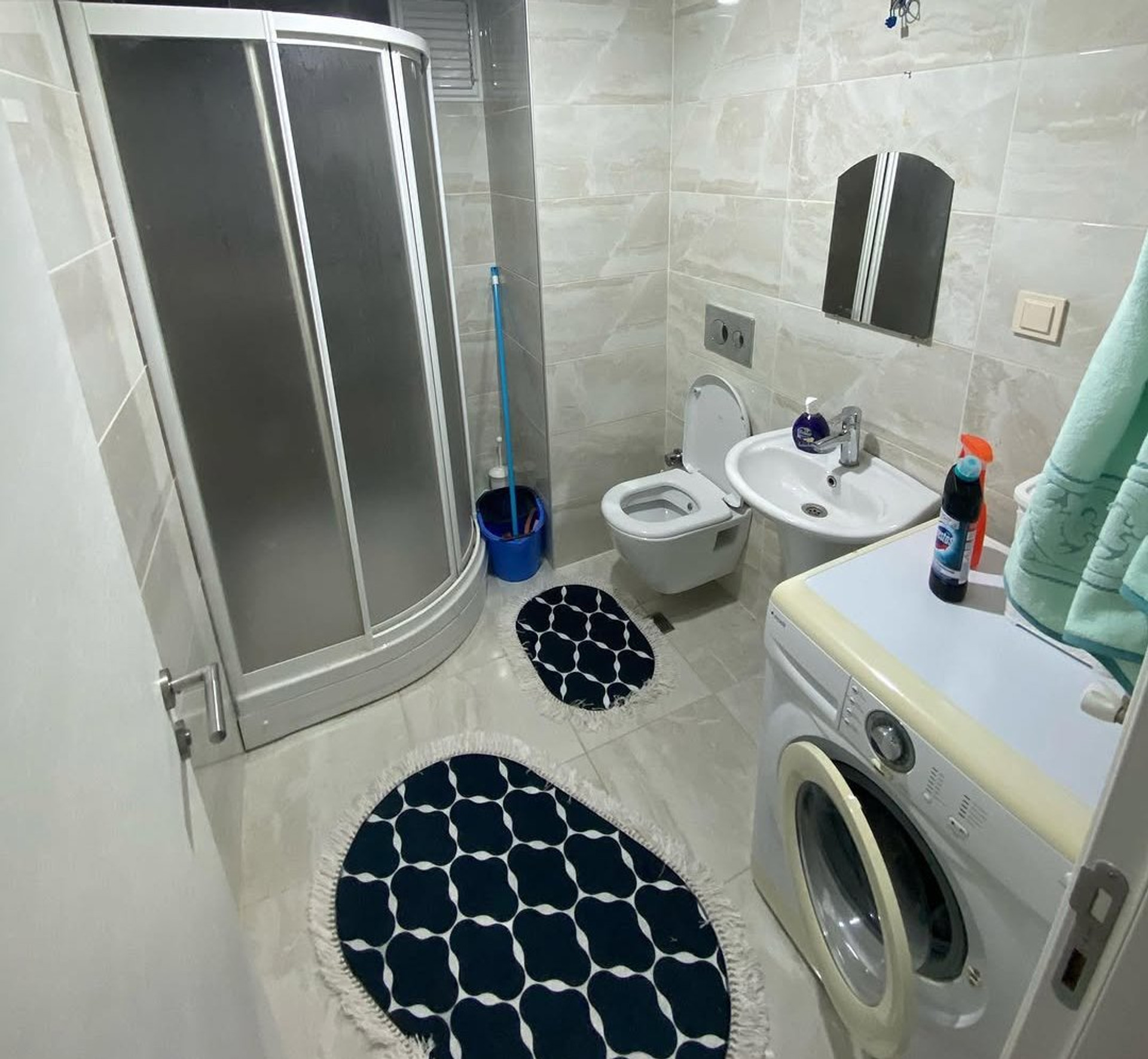 Bathroom with shower and washer