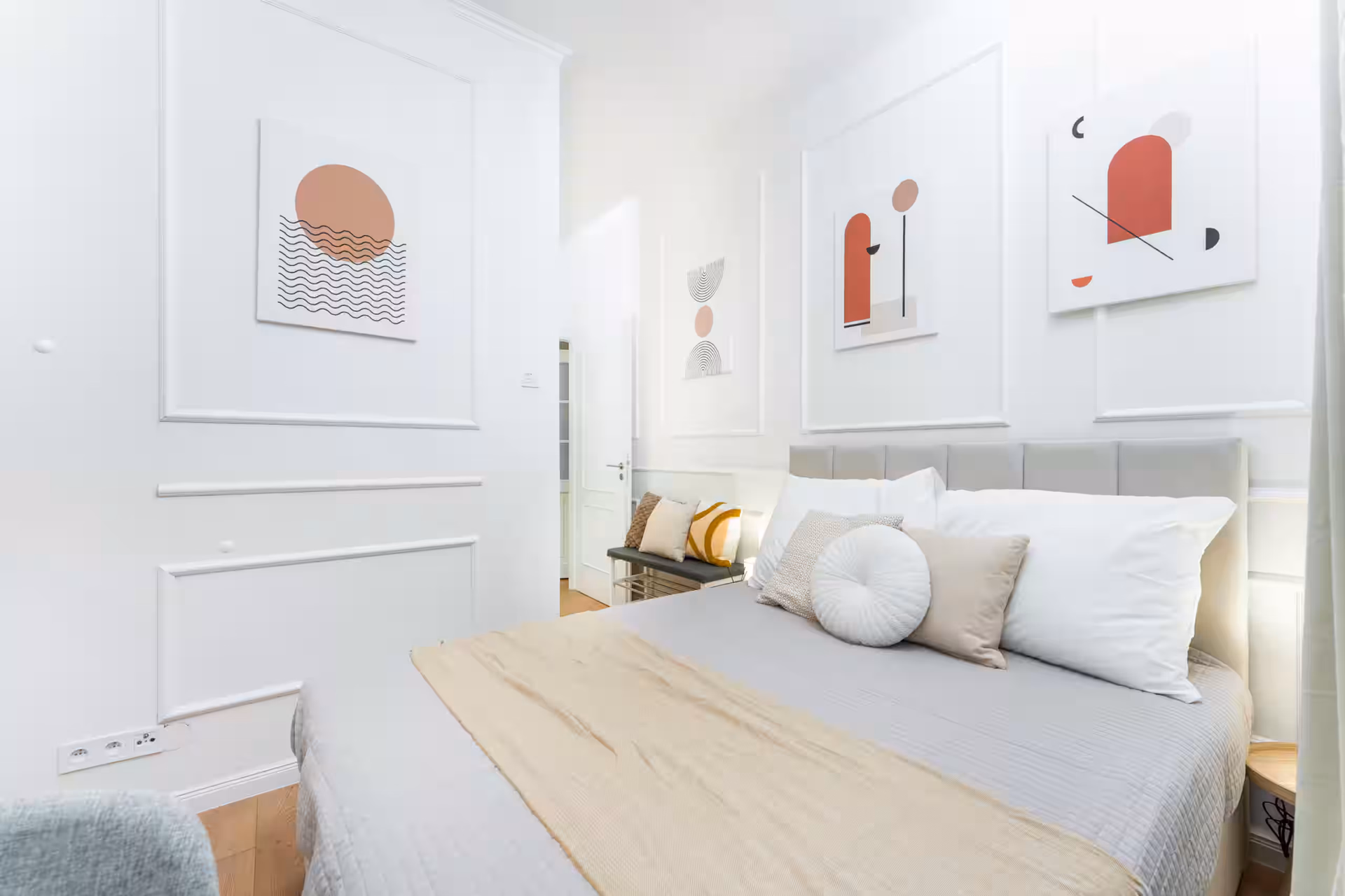 Bedroom with artwork and cozy bed