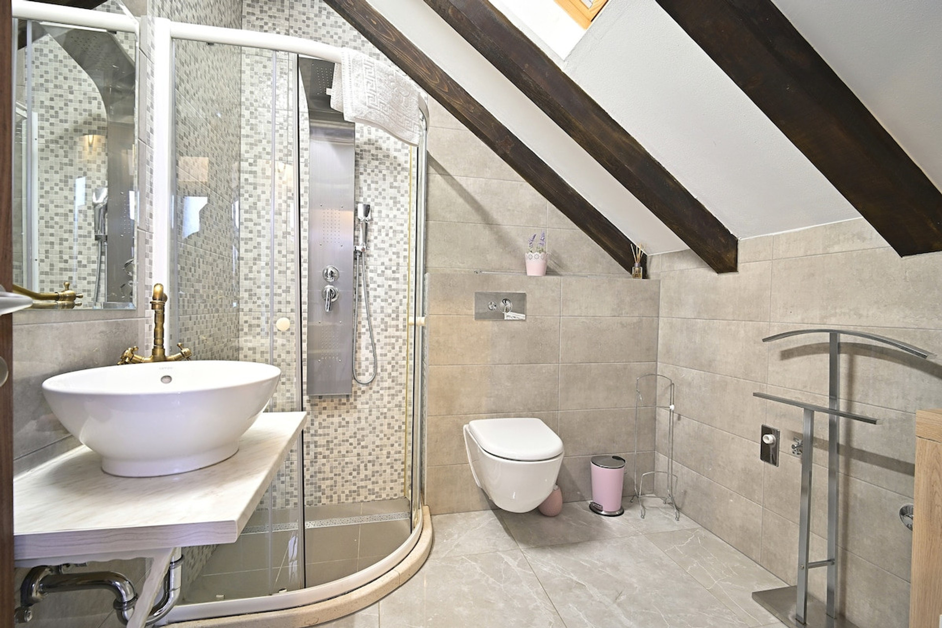 Full bathroom with shower and roof window.