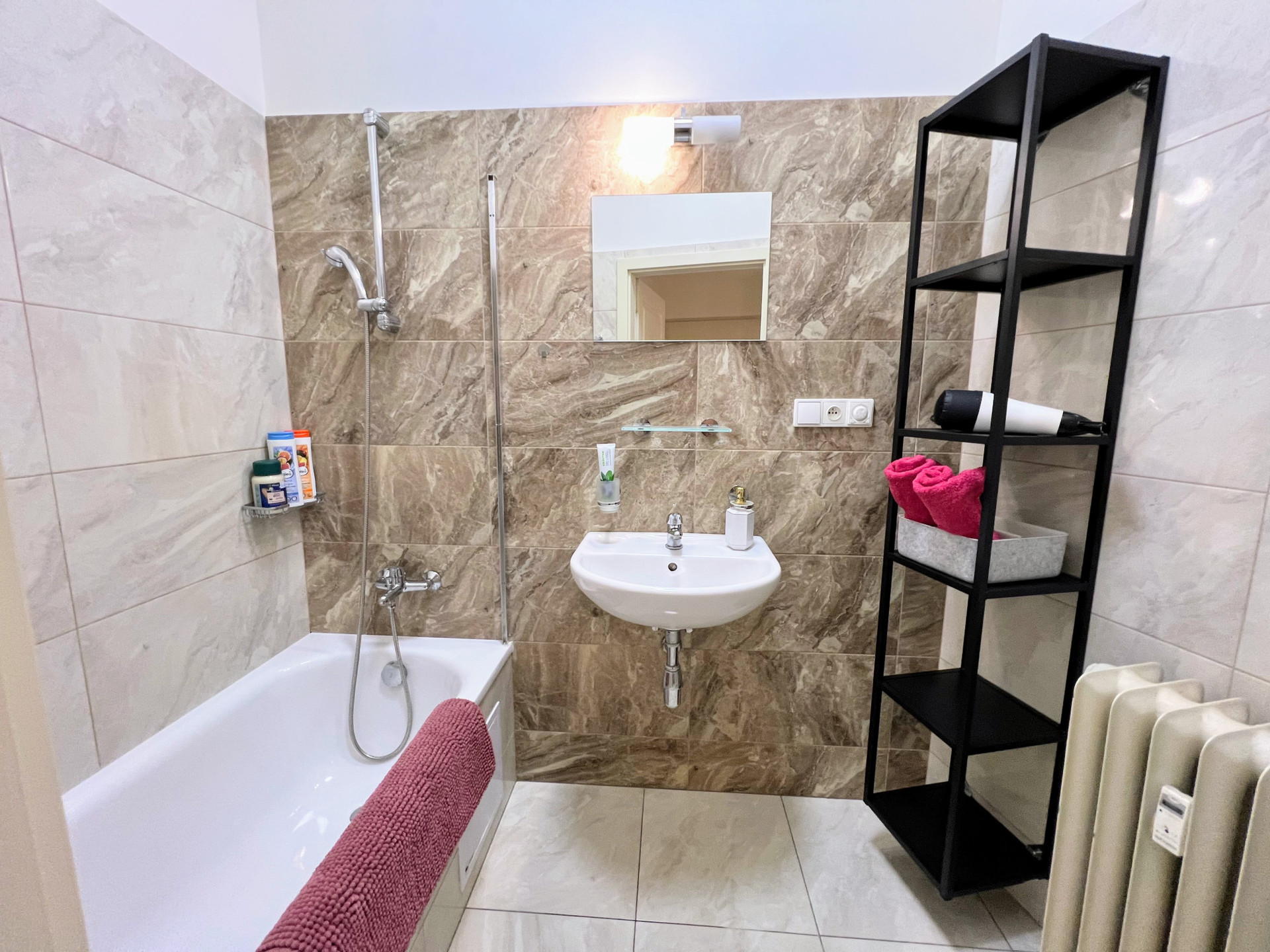 Marble tiled bathroom with tub