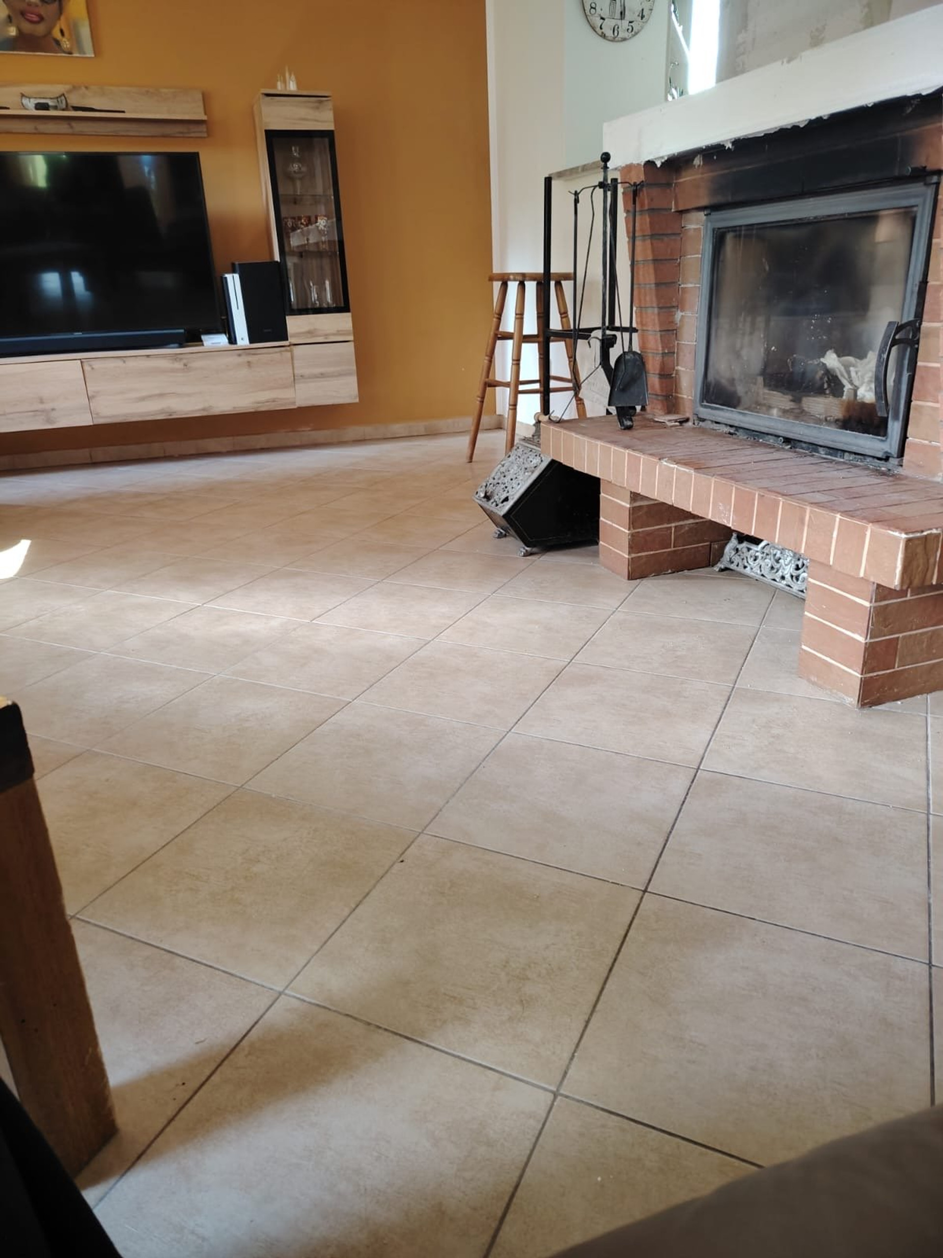 Living room with fireplace and TV