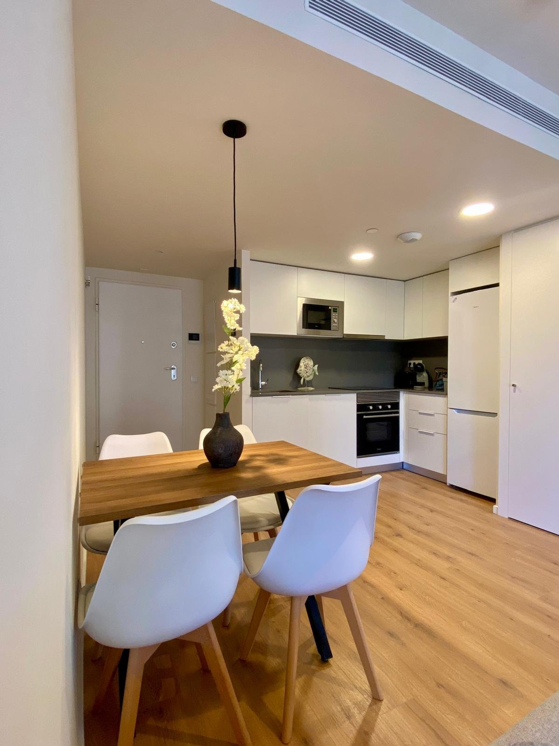Dining area with modern white kitchen