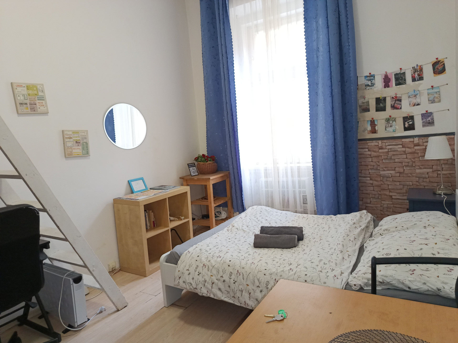 Apartment has a double bed, wardrobe, table, desk with chairs, night table, cabinets, ladder and loft with extra bed
