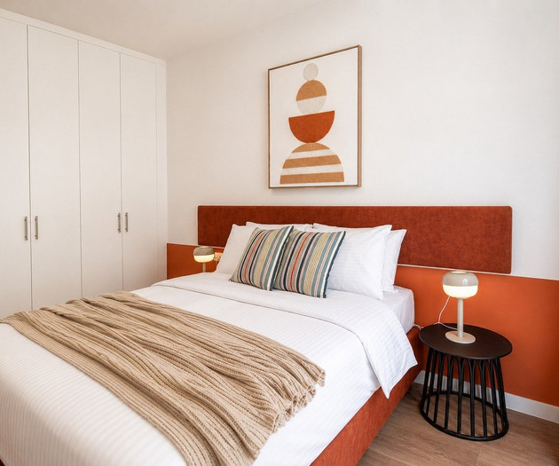 Bedroom with orange headboard